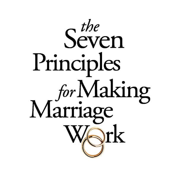 A book cover with two rings and the words " seven principles for making marriage work ".